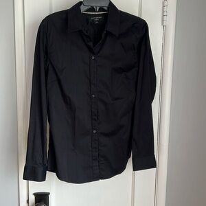 Tailor fitted black blouse in good condition.